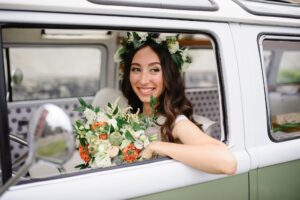 Bride driving a retro bus.