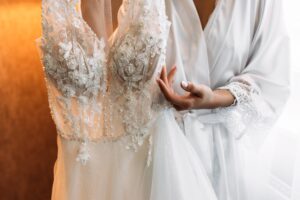 Bride holding wedding dress. The bride hugs the wedding dress