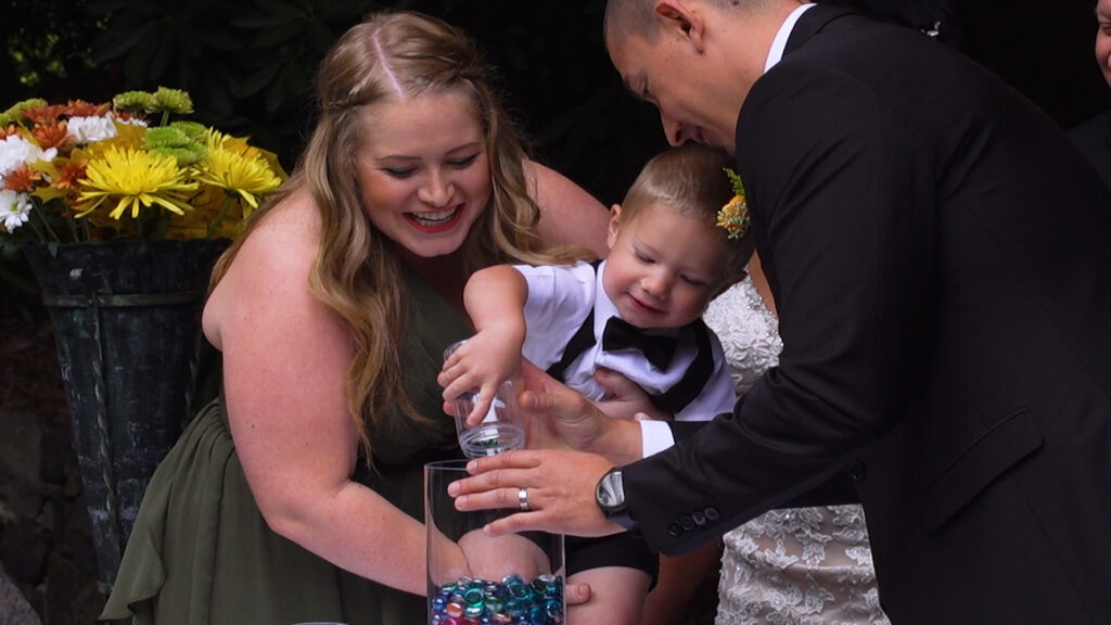 bride and groom with baby, wedding day