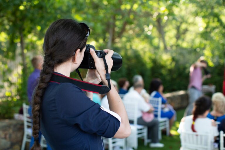 Photographer is a woman photographing a wedding ceremony